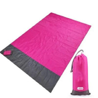 Mandotos sandproof portable beach mat spread out on sandy shore, lightweight and easy to carry for outdoor beach relaxation.