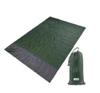 Mandotos sandproof portable beach mat spread out on sandy shore, lightweight and easy to carry for outdoor beach activities.
