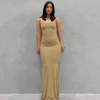 Mandotos sleek satin backless gown displayed on a mannequin, featuring a fitted design and elegant neckline.