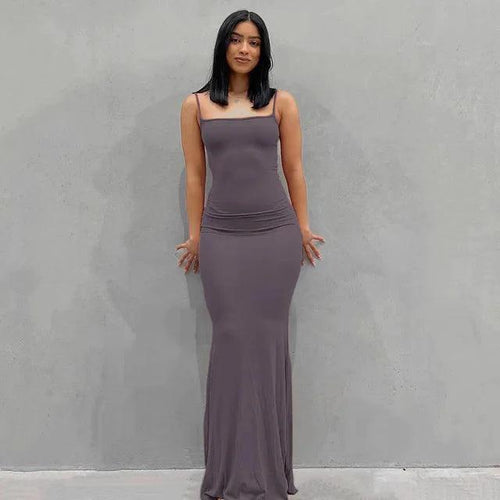 Mandotos sleek satin backless gown with a fitted silhouette, smooth fabric, and elegant design for formal occasions.