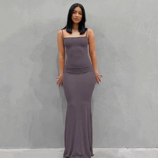 Mandotos sleek satin backless gown with a fitted silhouette, smooth fabric, and elegant design for formal occasions.