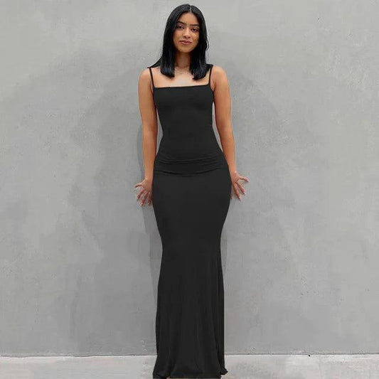 Mandotos sleek satin backless gown featuring a smooth, shiny fabric and elegant design perfect for formal occasions.