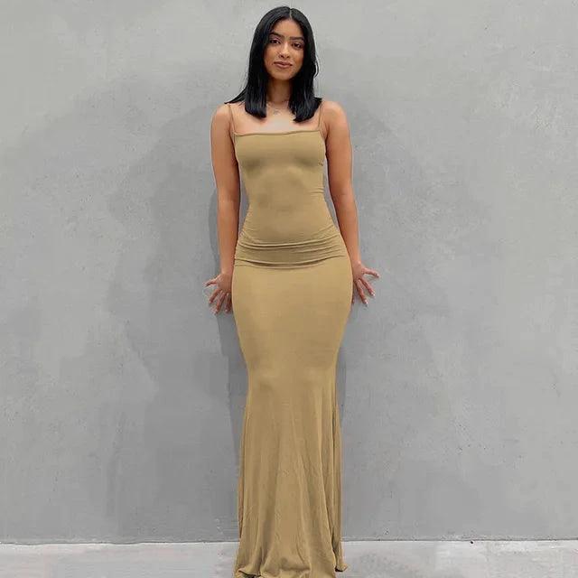 Close-up of MANDOTOS sleek satin backless gown, showcasing smooth fabric and elegant design on a model.