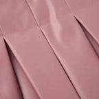 Mandotos Spice Faux Leather Pleated Mini skirt showcasing its textured pleats and rich faux leather material.