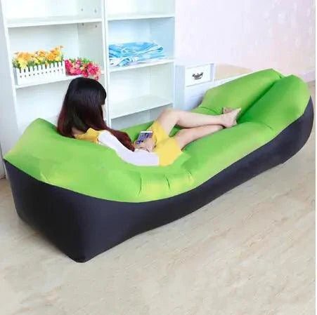 Mandotos SunScape inflatable lounger laid out on grass, showcasing its lightweight design and comfortable shape for outdoor relaxation.