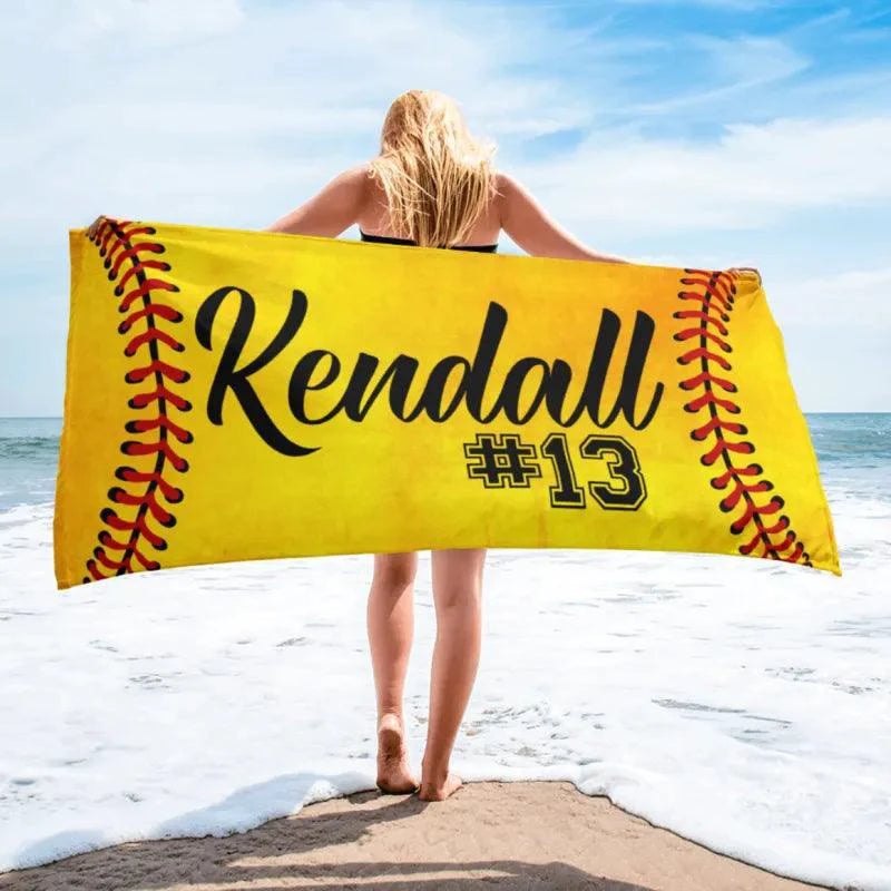 Mandotos SwiftDry patterned beach towel with colorful geometric design laid out on the sand.