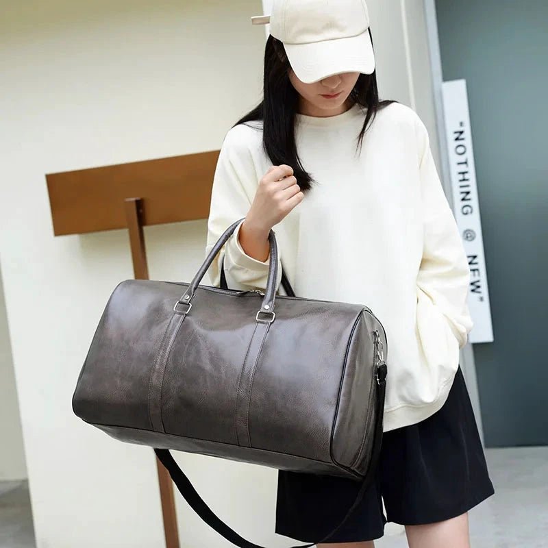 Mandotos travel bag for men and women featuring PU leather, large capacity, shoulder strap, and versatile duffle and crossbody style.