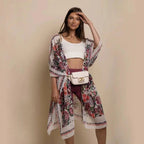 Mandotos Urban Blossom Kimono with floral pattern, lightweight fabric, and wide sleeves, displayed hanging on a wooden hanger.