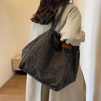 Urban Leopard Canvas Tote bag by MANDOTOS with leopard print pattern and sturdy handles, perfect for casual carry.