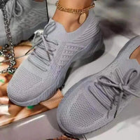 Mandotos walking shoes in black with white soles, featuring breathable mesh uppers and comfortable lace-up design.