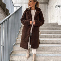Women's lamb wool coat by MANDOTOS, shown in a stylish, cozy design with a classic fit and soft wool texture.