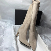 Women's high heel stretch below-the-knee boots by MANDOTOS, showcasing sleek black leather with pointed toes and stiletto heels.