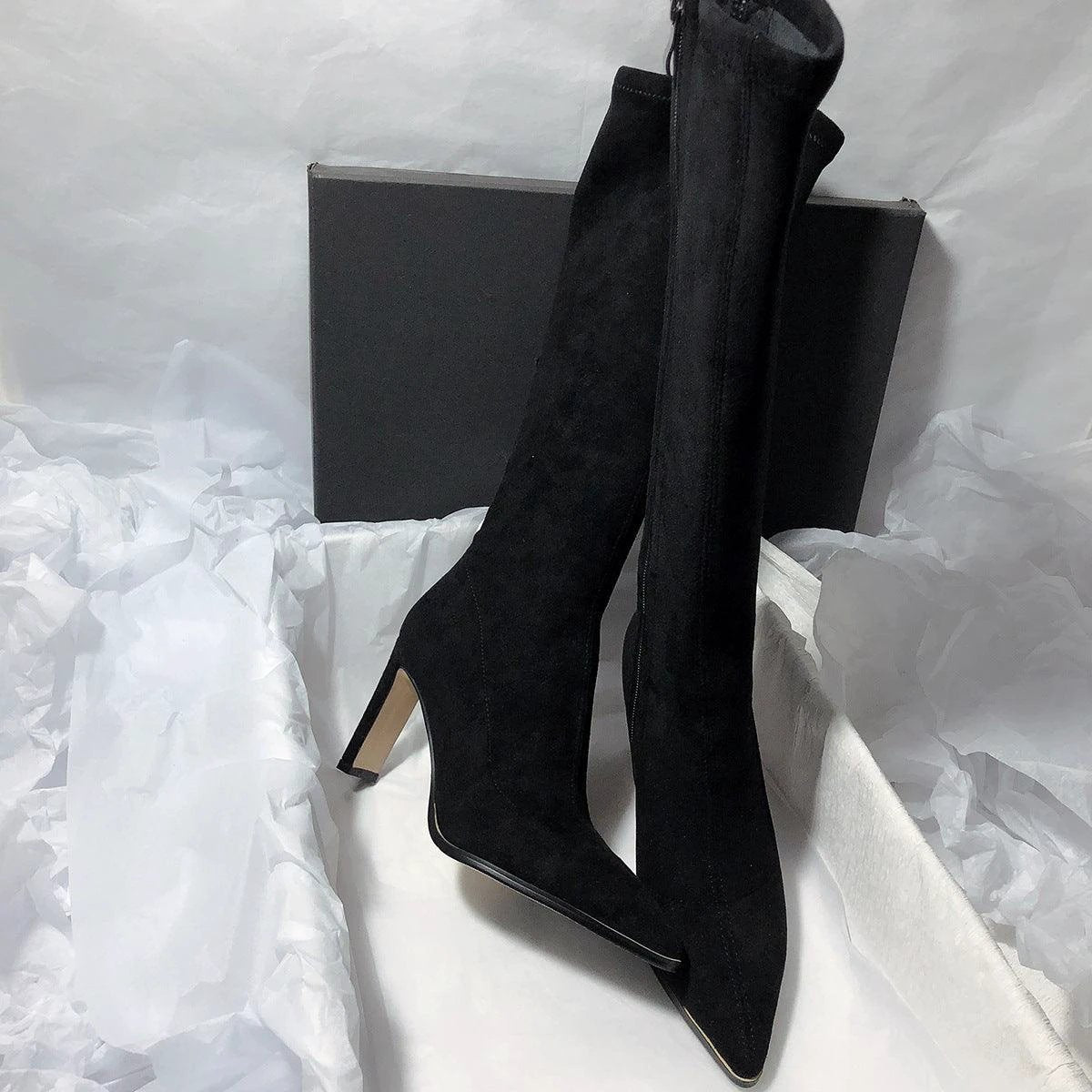 Women's high heel stretch below-the-knee boots by MANDOTOS showing sleek design and tall heel on smooth black material.