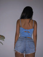 Mandotos Xuan Ya high-waisted denim shorts with hip zipper, casual summer style, shown on a model with a relaxed pose.