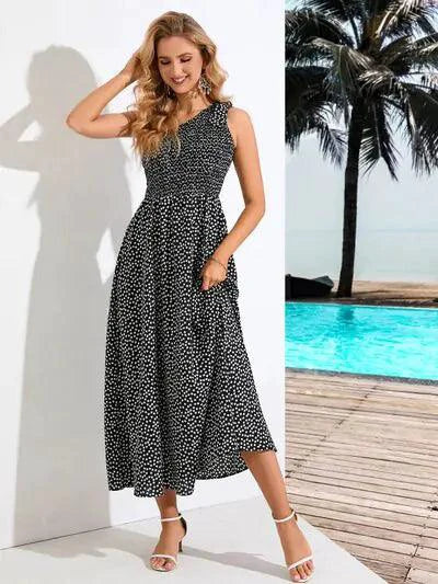 Mandotos Zoe asymmetrical midi dress in flowy fabric, featuring unique hemline and stylish design, worn by a model.
