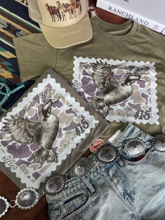 Wild Junkie Duck Stamp Graphic Tee in olive green, featuring a detailed duck stamp illustration on a casual graphic tee.